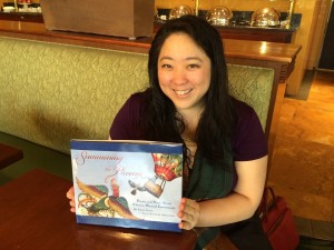 Author Emily Jiang holding her book Summoning the Phoenix. Photo by Theodora Goss.